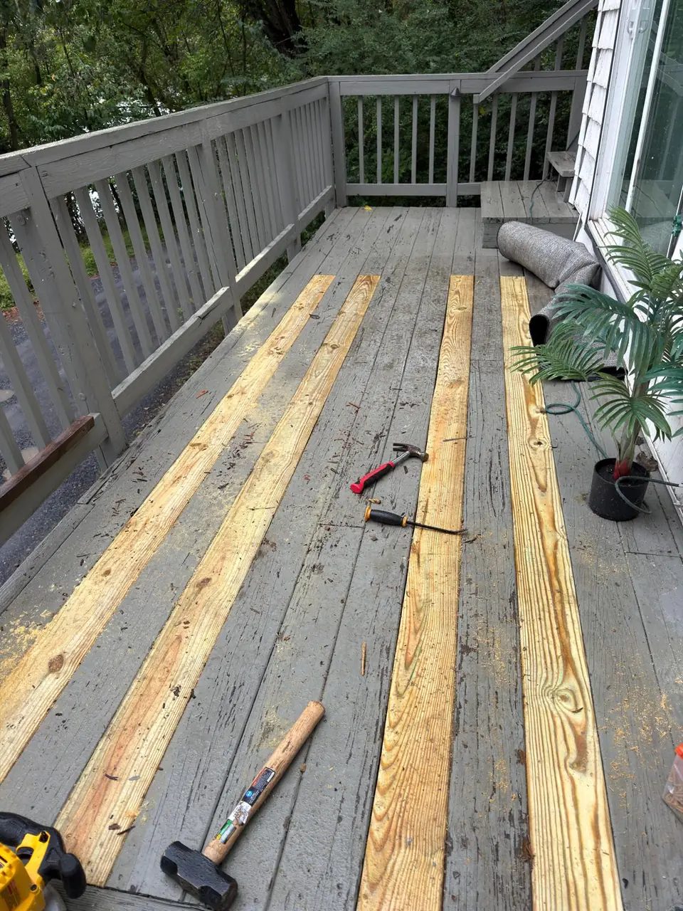 Close view of replacement boards across an existing deck