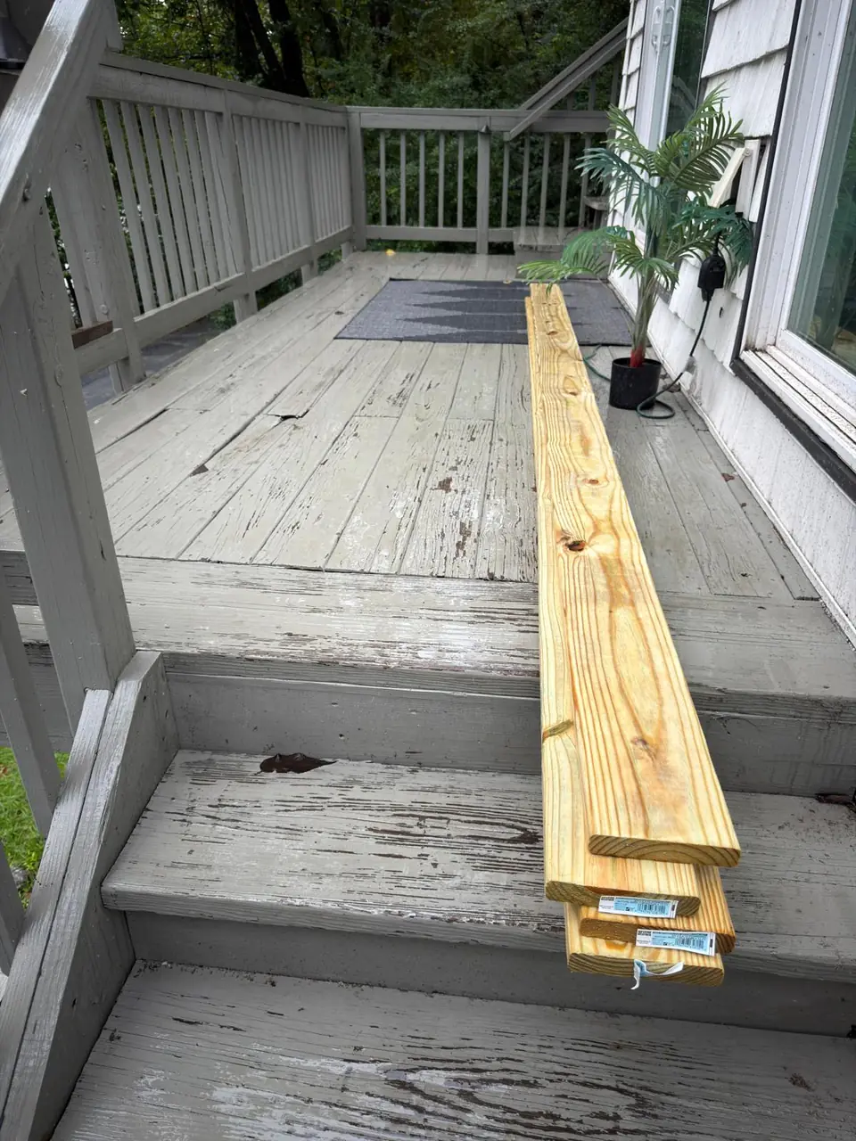 New deck boards prepared beside the existing steps