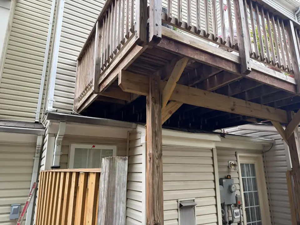 Deck support post, beam and bracing beside the house