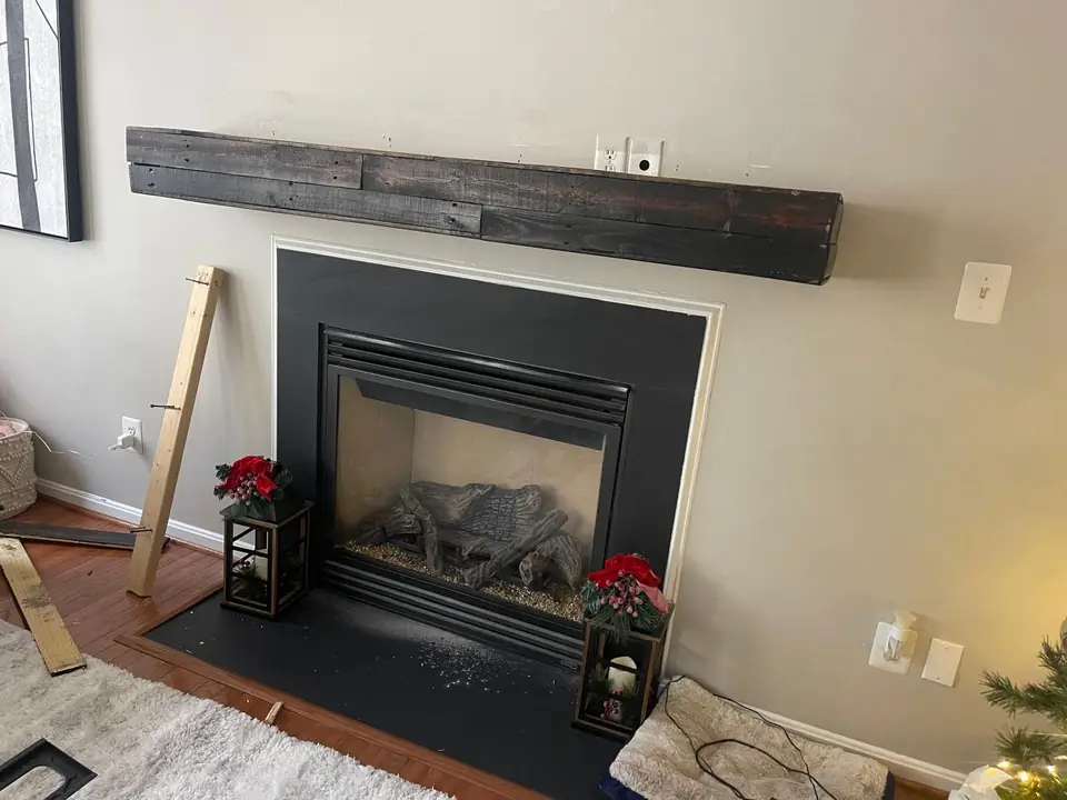 Dark wood mantel mounted above a fireplace
