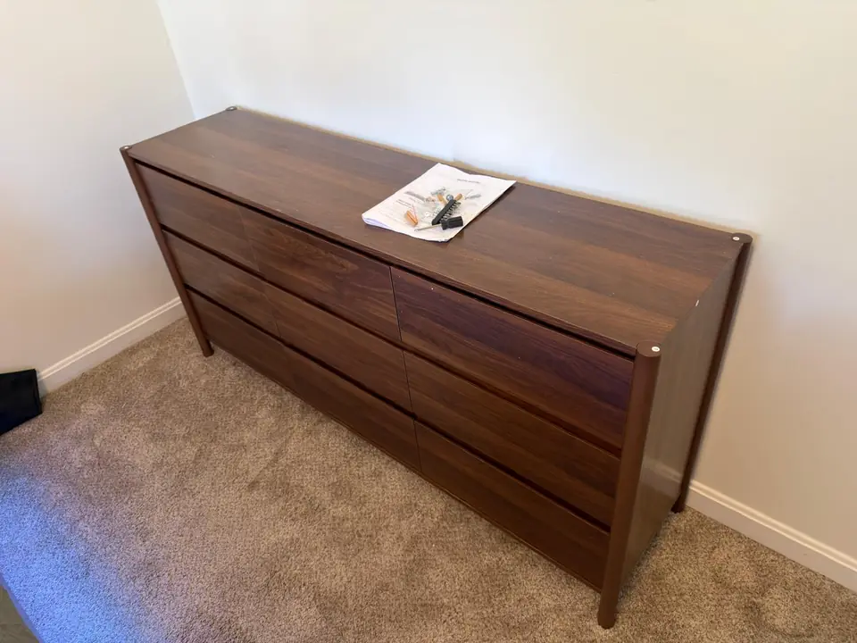 Assembled dresser with instructions and hardware on top