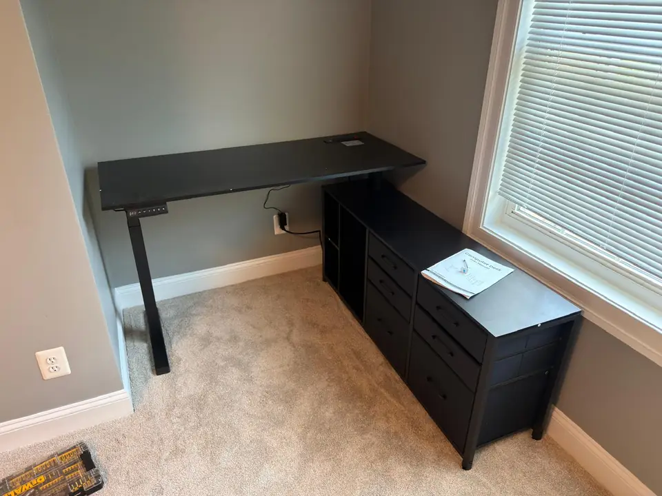 Assembled black home-office desk with storage drawers and shelves