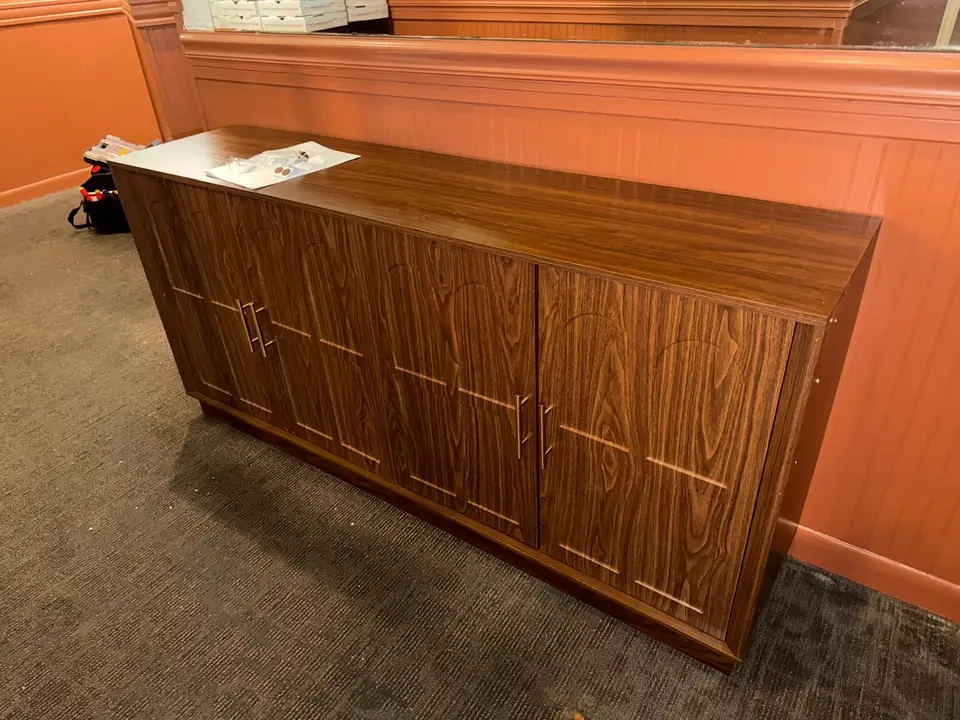 Assembled brown storage cabinet with doors and handles