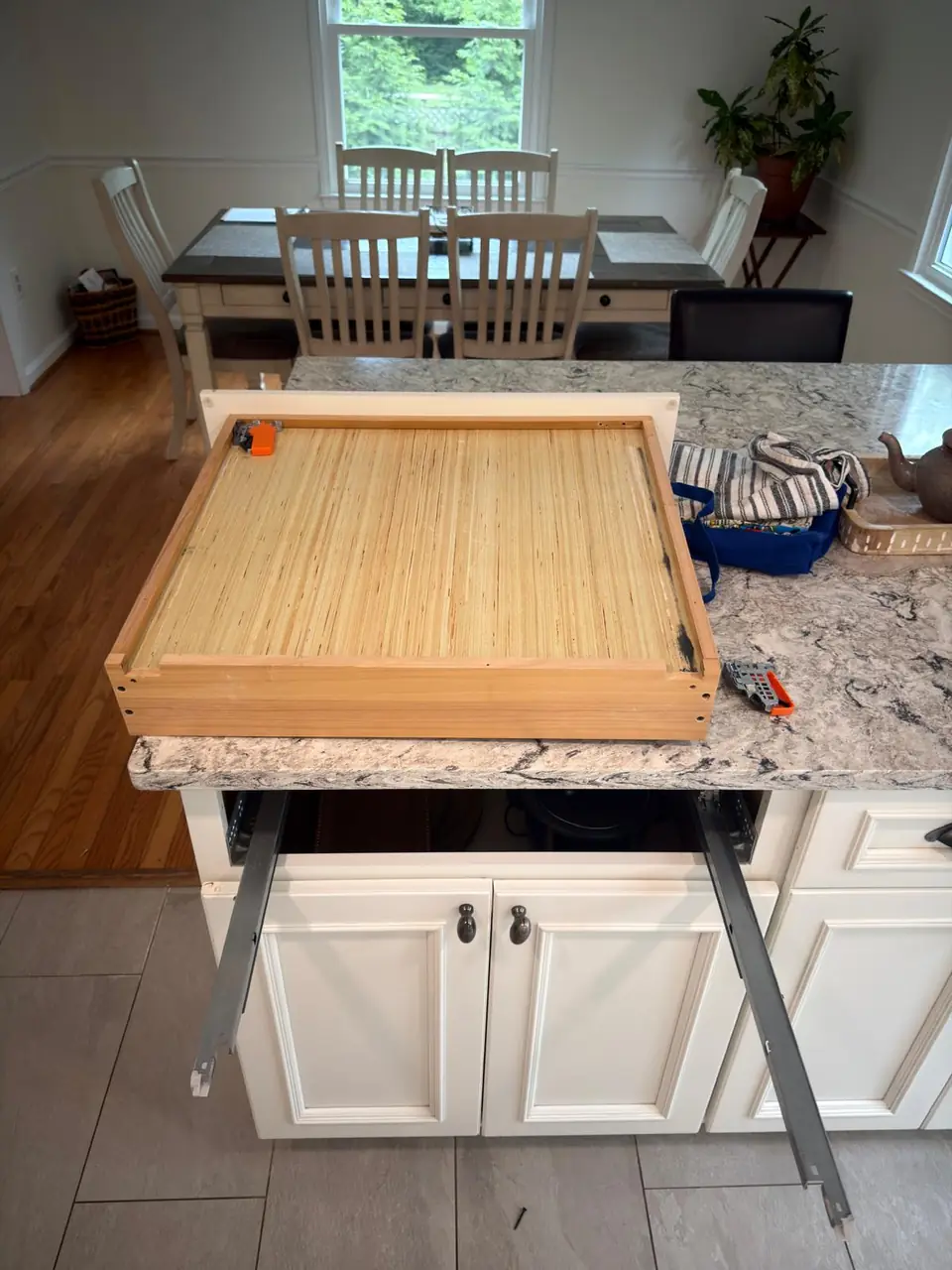 Underside of a kitchen drawer and its slide-release hardware