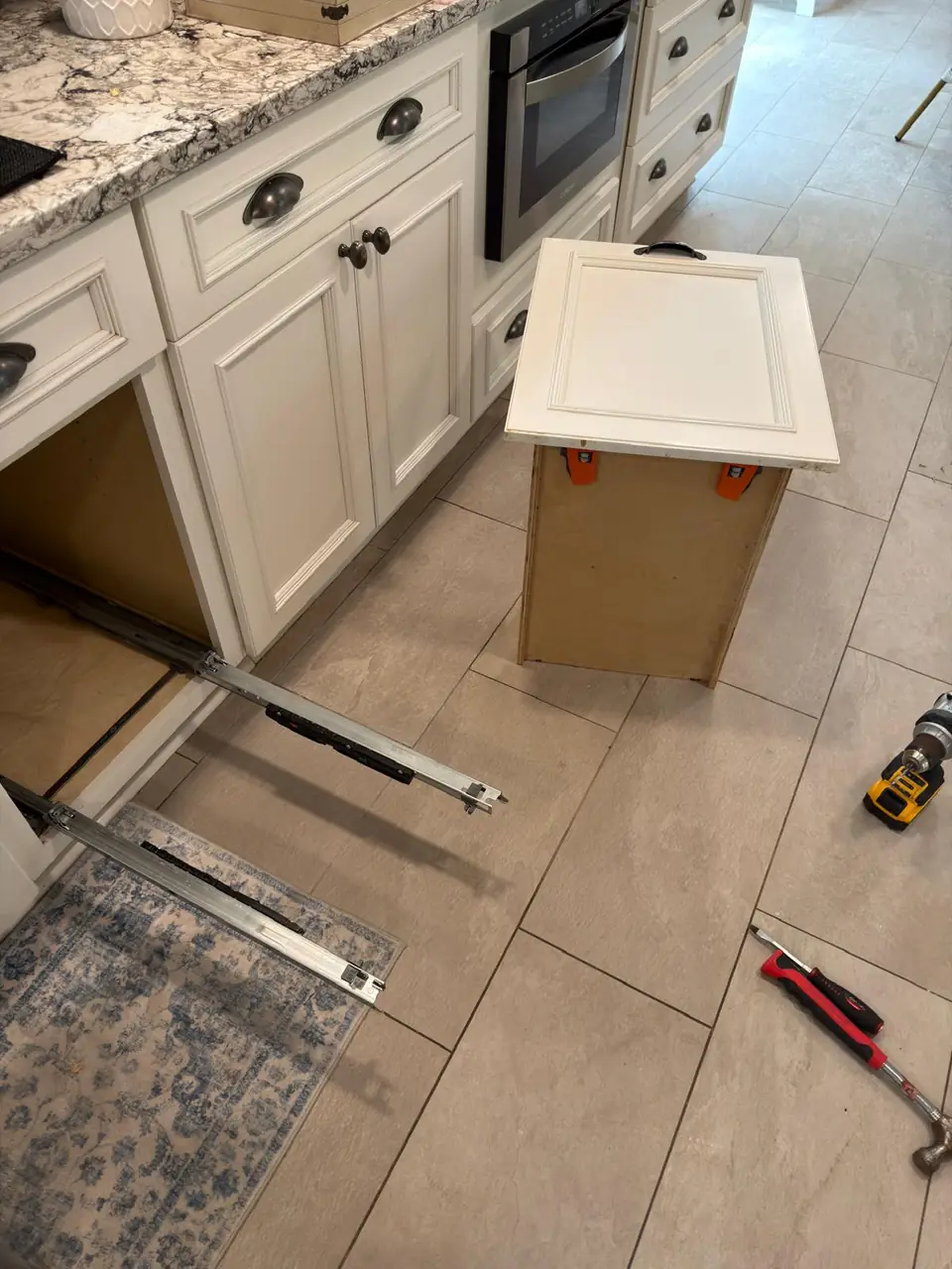 Drawer removed beside the kitchen cabinet during hardware repairs