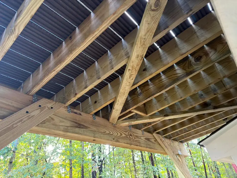 Wood beams, joists and diagonal braces underneath the deck