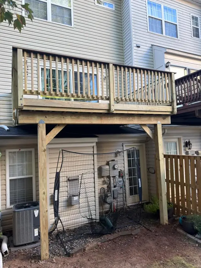 Front view of the new raised deck, wood railings and support posts