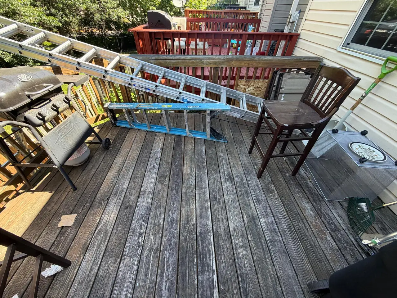 Original deck surface with tools and furniture before work