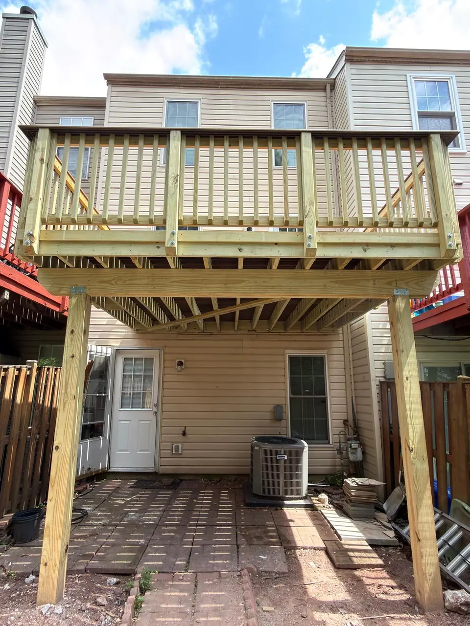 Completed elevated deck with new posts, railings and framing